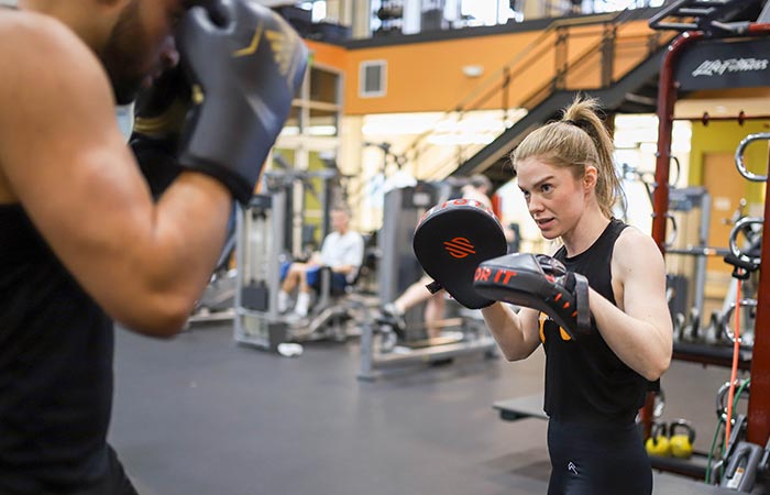 Two people spar during boxing class at Mac Seattle Athletic Club